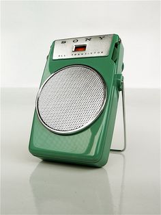 a green radio sitting on top of a white table