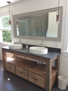 a bathroom with two sinks and a large mirror above it's countertop area