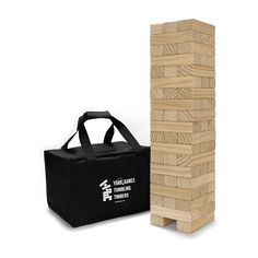 a wooden block tower next to a black canvas bag on a white background, with the word's logo printed on it