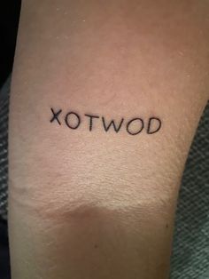 a tattoo that reads xotwod on it