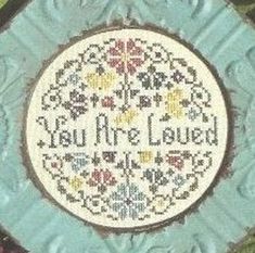 a blue and white plate with the words you're loved on it