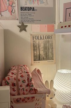 a child's room with pink and white decor on the walls, bedding and other items