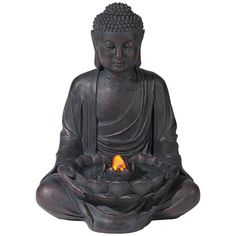 a buddha statue with a lit candle in its lap