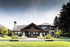 a large house sitting on top of a lush green field