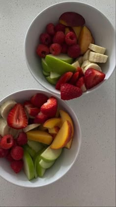 two white bowls filled with different types of fruit