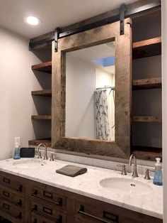 a bathroom with two sinks and a large mirror