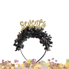 a black and gold wreath with the word hello spelled on it's top, surrounded by confetti