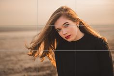 a woman with long hair standing in front of a tiled wall and looking at the camera