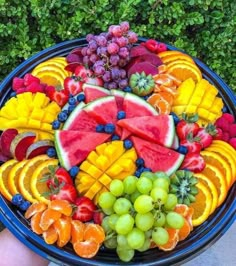 a platter filled with lots of different types of fruit