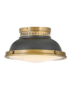 an image of a ceiling light that is gold and grey with dim lighting on it