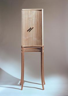 a wooden chair with a door on the back and legs that are made out of plywood