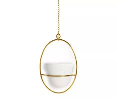 a white bowl is hanging from a gold - plated metal circle on a chain