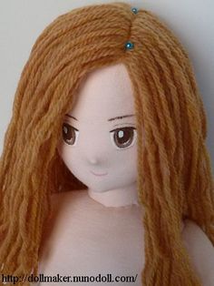 a doll with long blonde hair and brown eyes