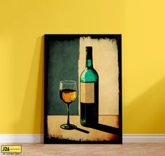 a wine glass and bottle on a table next to a yellow wall with a black frame