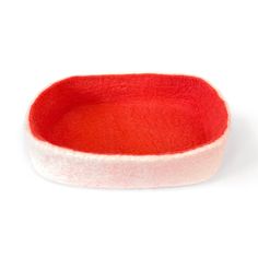 a red and white felt bowl on a white background with clipping for the bottom