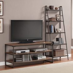 an entertainment center with bookshelves, shelves and a flat screen tv