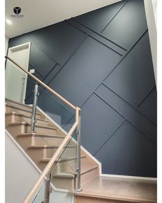 a stair case in front of a blue wall