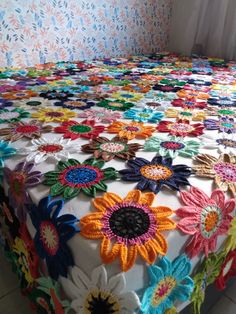 the bed is made with multicolored crochet and has a floral design on it