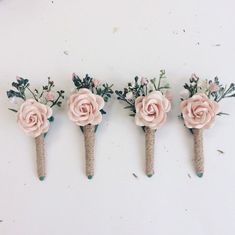 four pink flowers are placed on top of each other in the shape of three branches