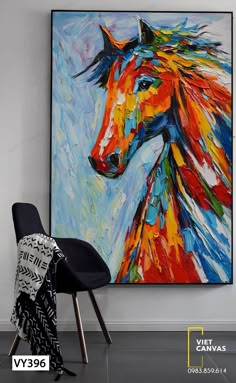 a colorful horse painting hanging on the wall next to a black chair and white floor