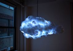 a cloud shaped light hanging from the ceiling