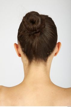 the back of a woman's head with her hair in a bun