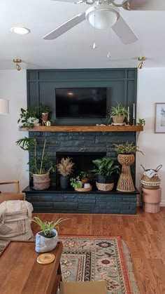 a living room filled with furniture and a flat screen tv mounted above a fire place