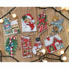 christmas ornament ornaments are displayed on a wooden table with lights and decorations around them