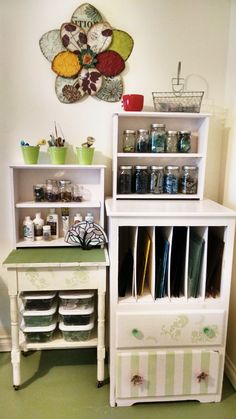 a white cabinet with drawers and shelves filled with items