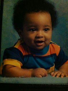 a baby is smiling and posing for a photo