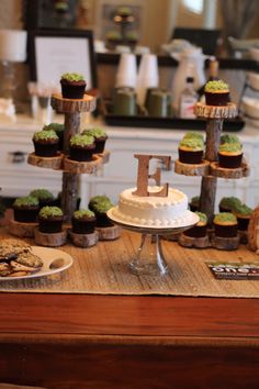 a table topped with lots of cupcakes covered in frosting