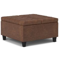 a brown ottoman sitting on top of a white floor