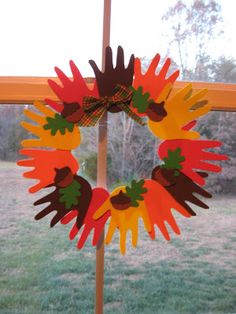 a wreath made out of paper sitting on top of a pole in front of a window