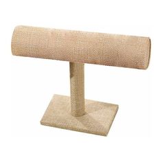 a roll of burlap on a metal stand with a white backdrop behind it