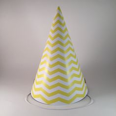 a yellow and white party hat on a plate