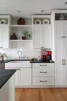 the kitchen is clean and ready for us to use it's white cabinetry