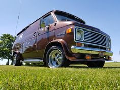 an old van is parked in the grass