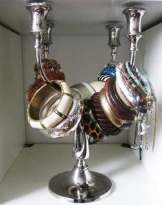 a silver candelabra filled with lots of jewelry