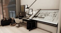 a computer desk with a large blueprint on it