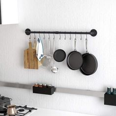 pots and pans are hanging on the wall