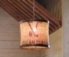 a chandelier hanging from the ceiling in a room with wood paneling and beams