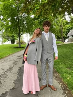 a young man and woman dressed in formal wear