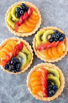 four fruit tarts on top of each other