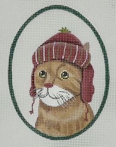 a cross - stitch picture of a cat wearing a red hat and ear muffs