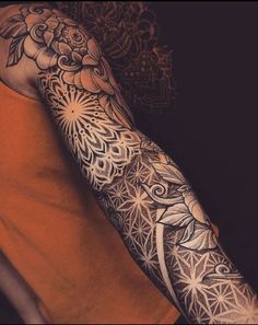 a man's arm with an intricate tattoo design on the arm and shoulder,