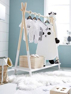 a child's room with blue walls and white furniture, including an animal themed crib