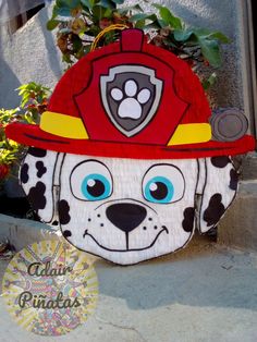 a fireman's hat made out of paper mache with a paw on it