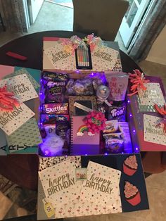 a table topped with lots of birthday cards and gifts