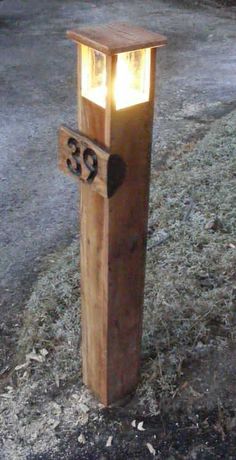 a wooden post with a lit up number on it