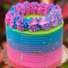 a multicolored cake with flowers on top